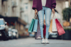 Big sale. Cropped portrait of stylish girl holding colorful shopping bags